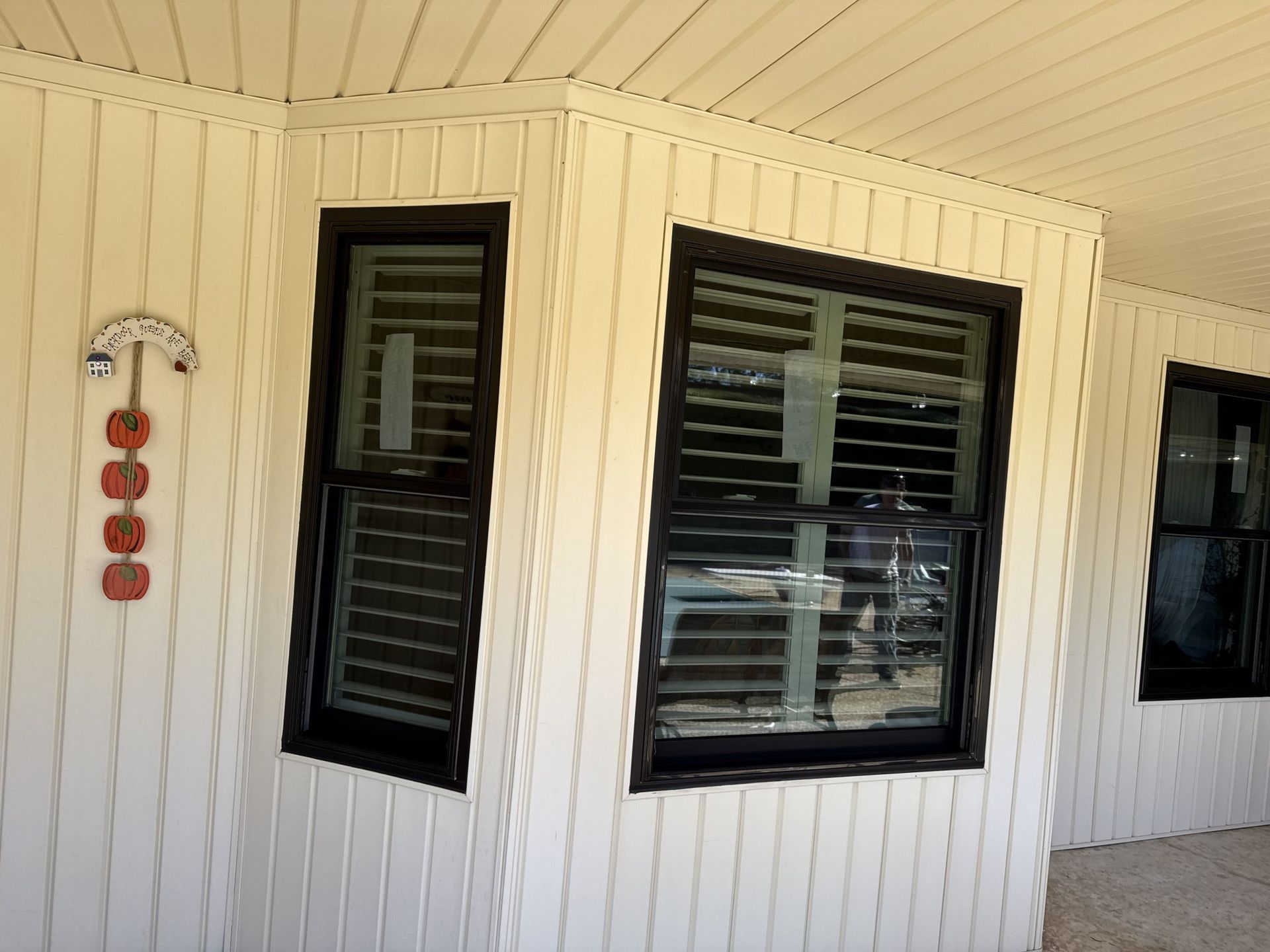 A white house with black windows and shutters