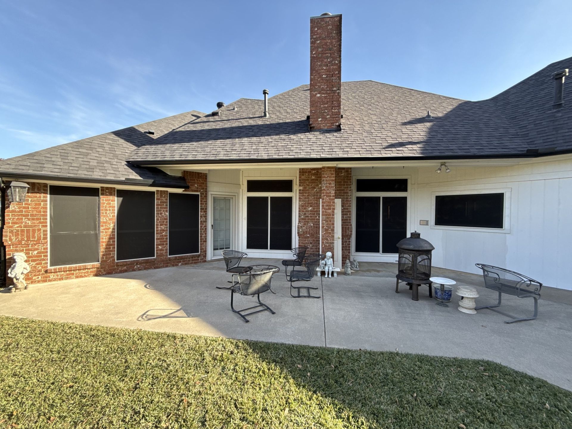 The back of a house with a patio and a fire pit.