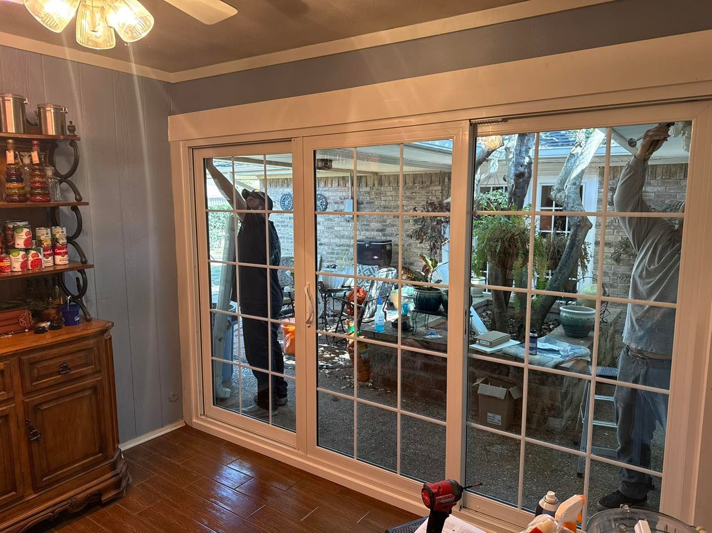 A living room with sliding glass doors and a ceiling fan.