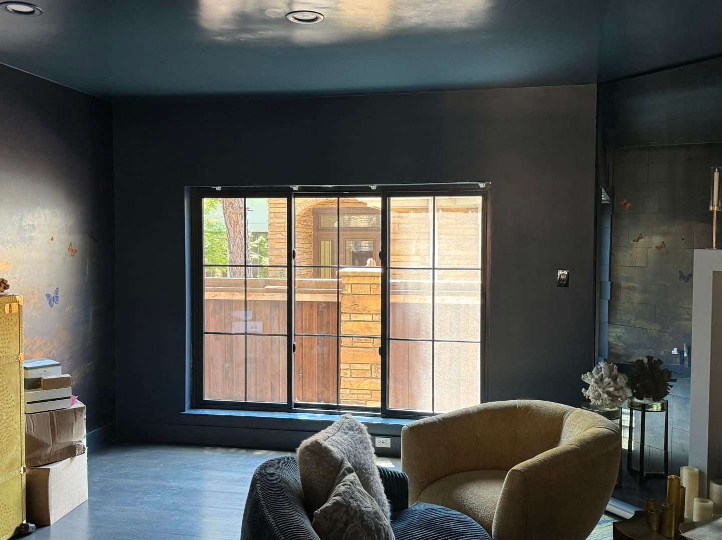 A living room with two chairs and a large window