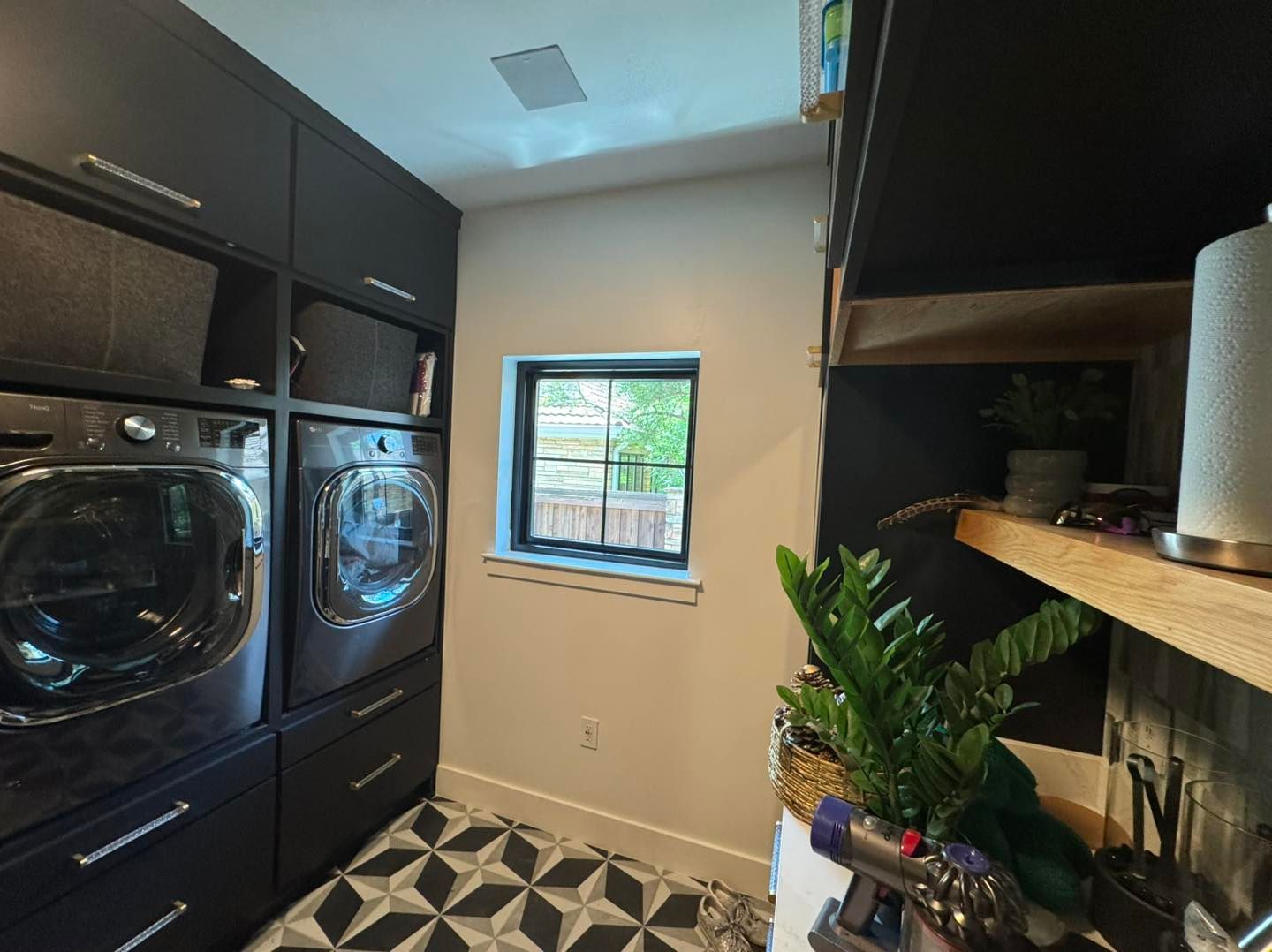 A laundry room with a washer and dryer and a window.
