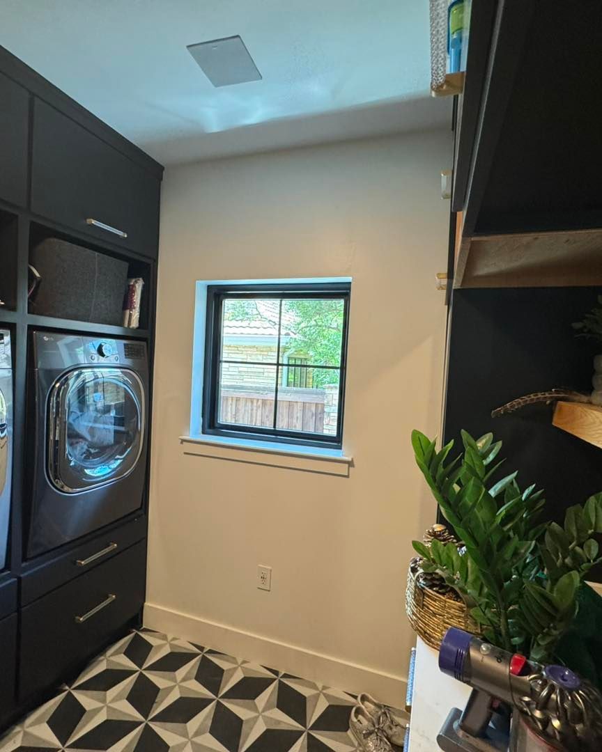 A laundry room with a washer and dryer and a window.