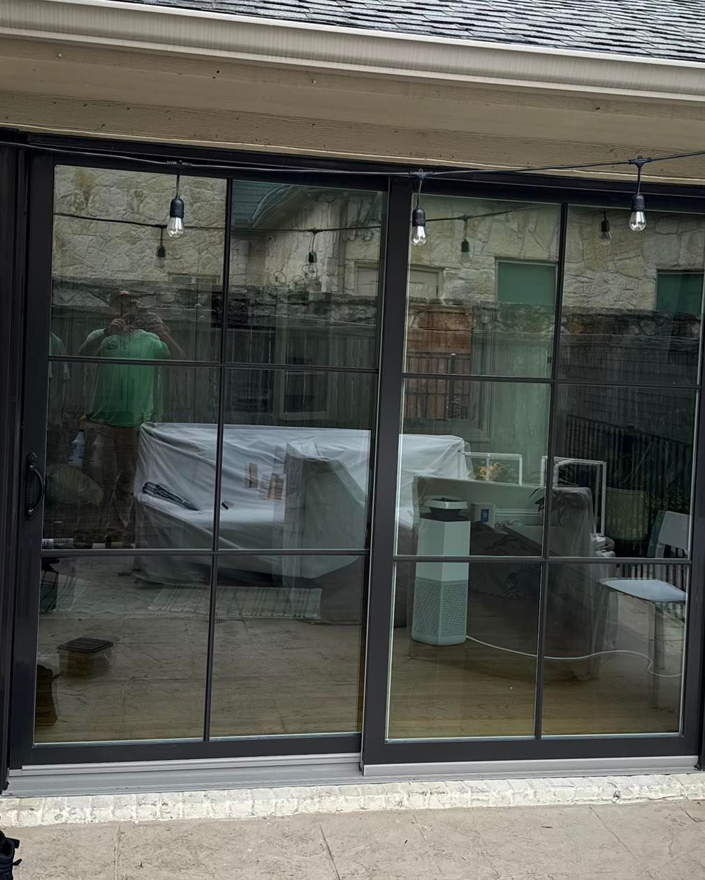 A patio with sliding glass doors leading to a living room.