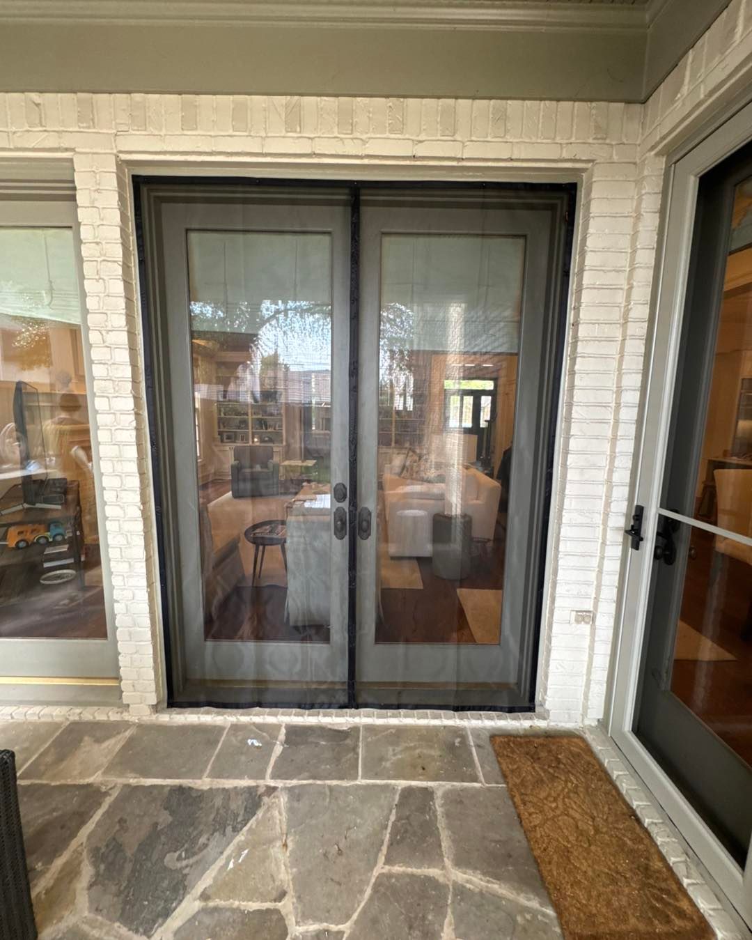 A patio with sliding glass doors and a screen door.