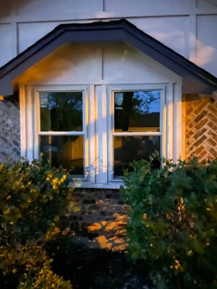 A house with a large window and a brick wall.