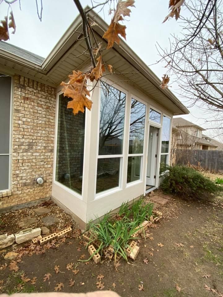 A house with a lot of windows and a tree in front of it.