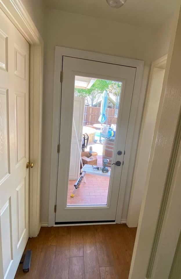 A hallway with a sliding glass door leading to a patio.