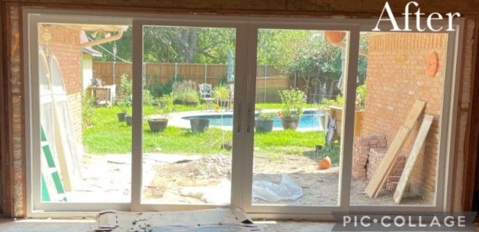 Sliding glass door with view of backyard, pool, and wooden planks.