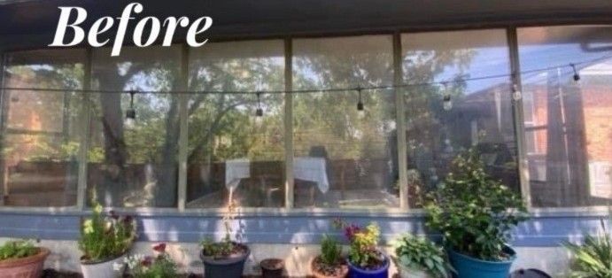View of a porch with glass windows and potted plants in the foreground. The windows are labeled 