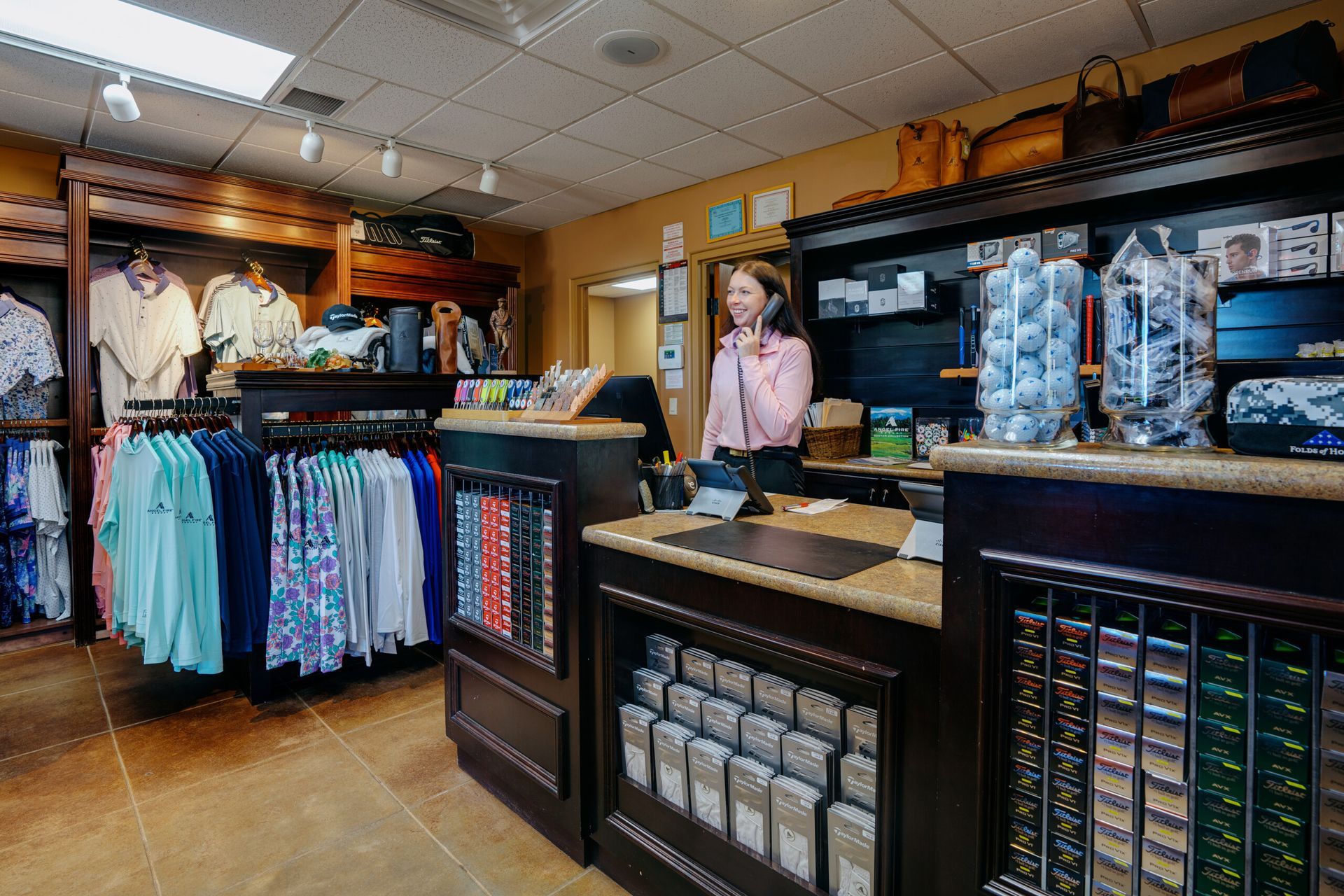 Pro shop staff member at Angel Fire Resort managing tee times—highlighting the need for tools like Fairway Control to eliminate manual booking costs.