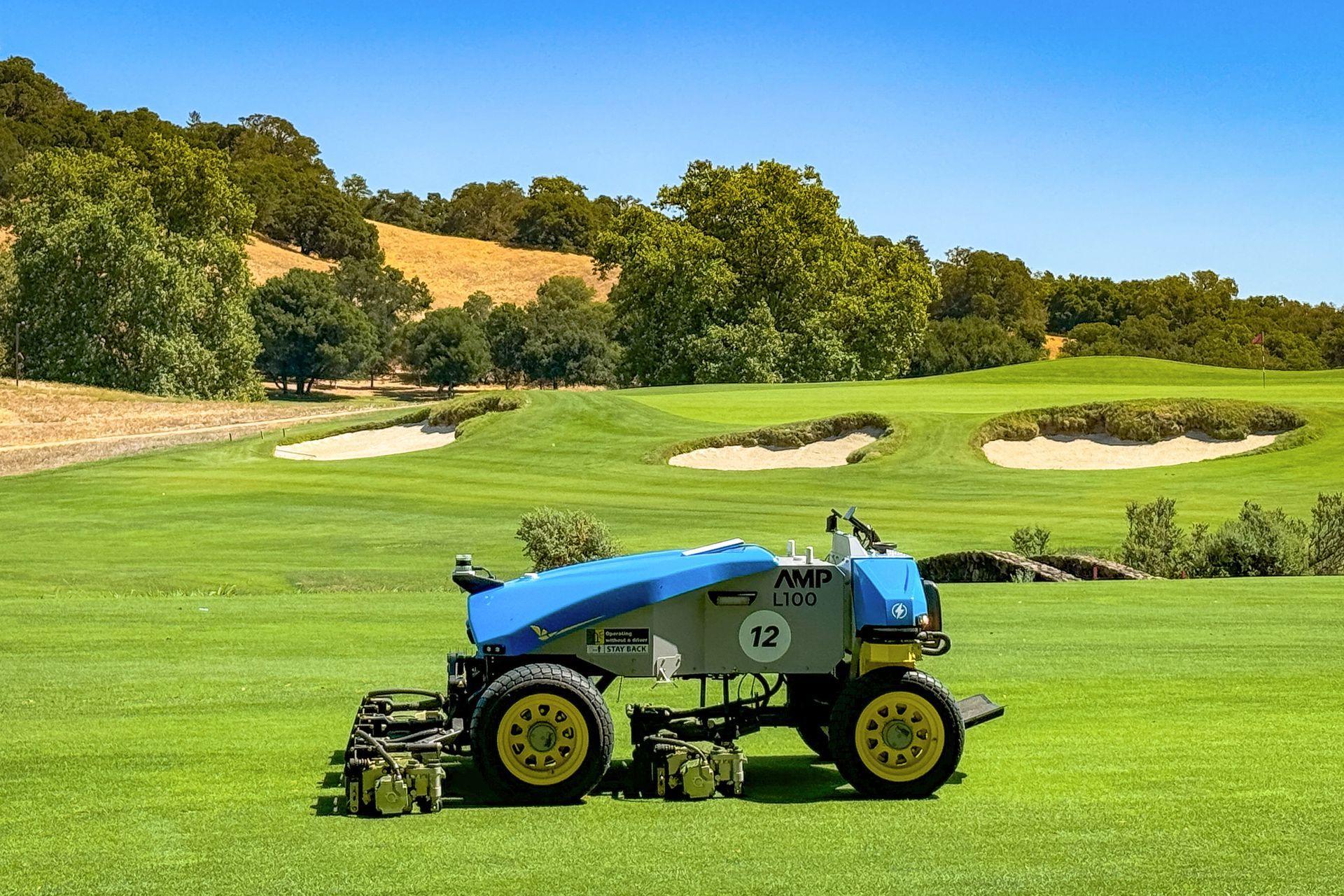 Autonomous mower trimming a golf course fairway, showing modern turf care in action.