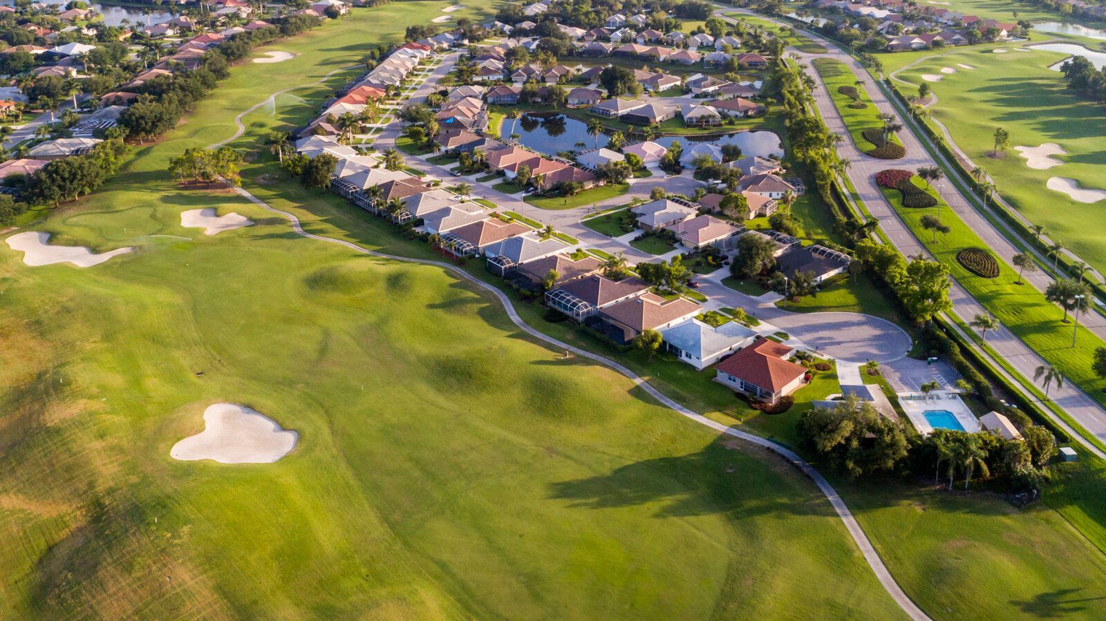 Golf course with residential homes lining the fairways in a scenic golf community.