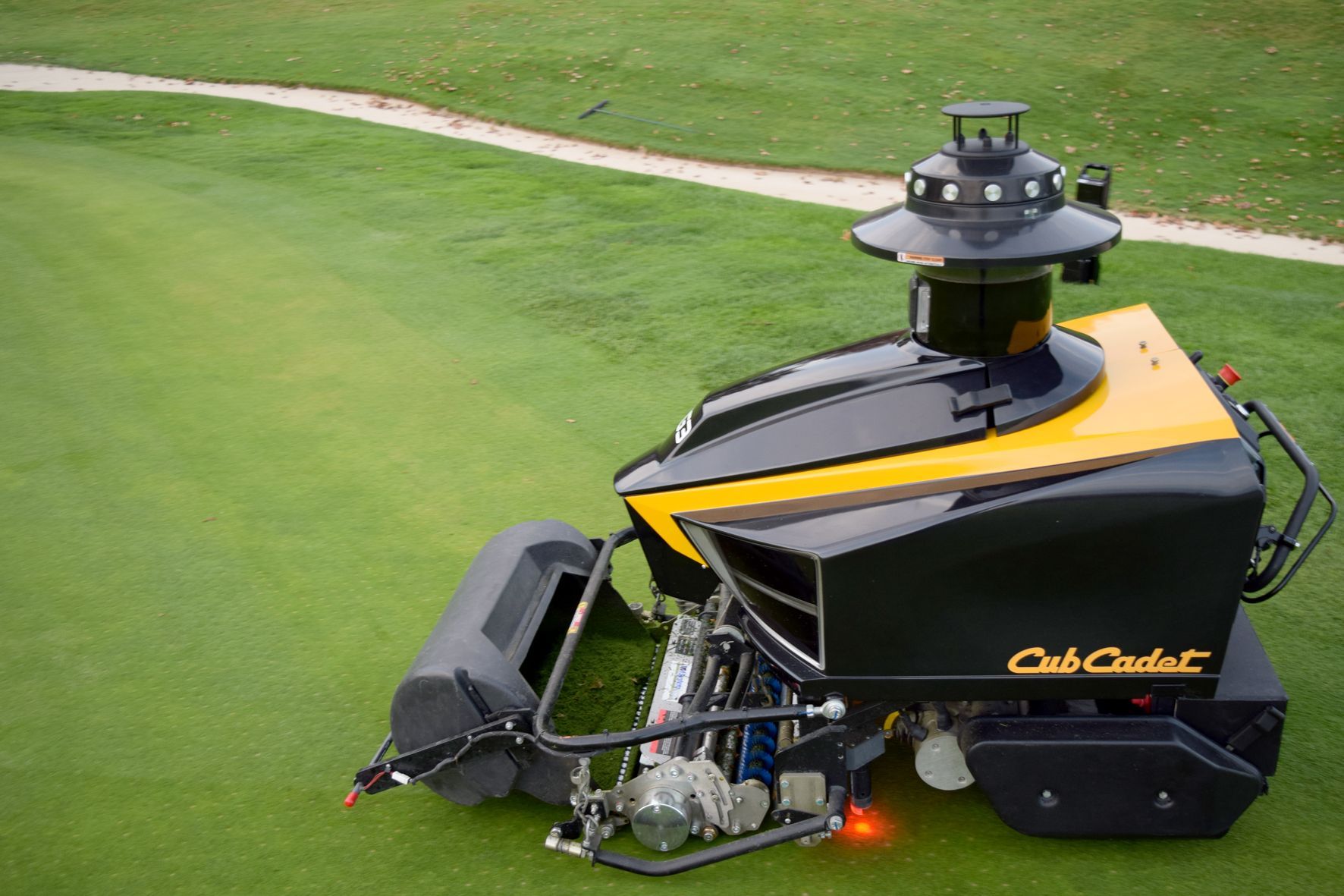 Cub Cadet RG3 autonomous greens mower in action on a golf course, representing modern turf management technology and precision mowing on bentgrass or Bermuda greens.