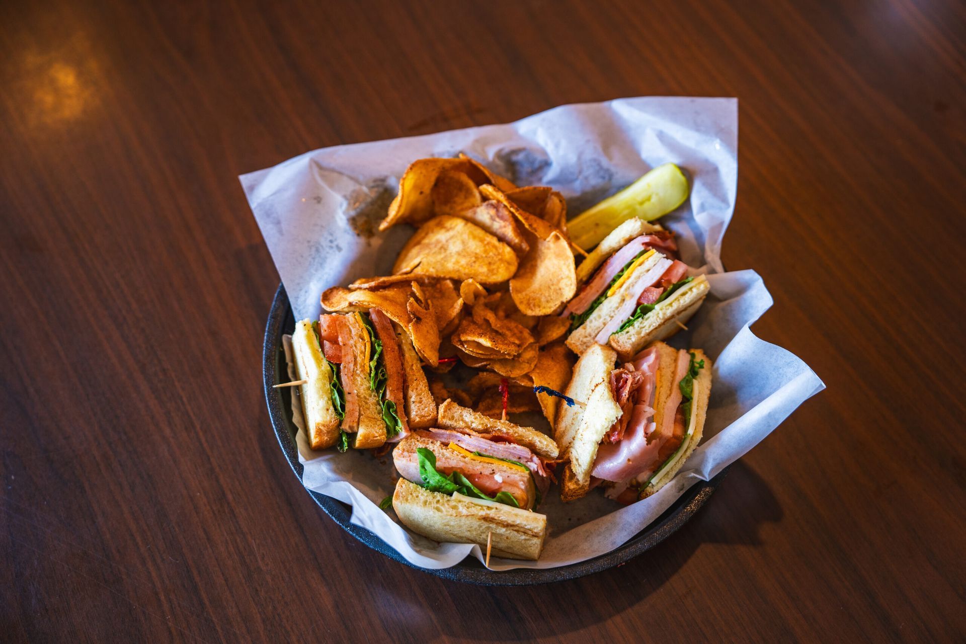 Club sandwich at a golf clubhouse, showcasing turn-time food options.