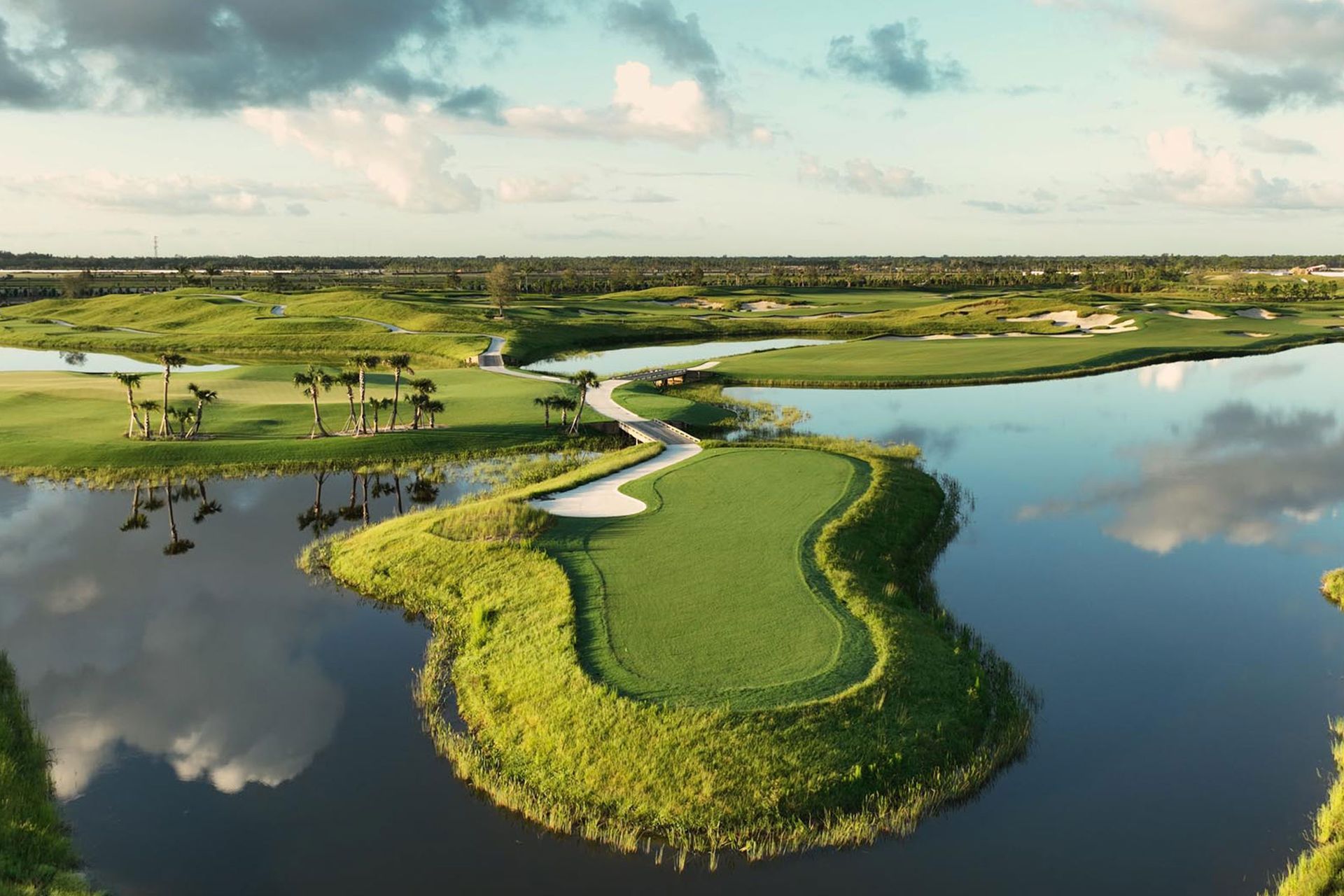Aerial view of a professionally designed 18-hole golf course with pristine fairways and greens.