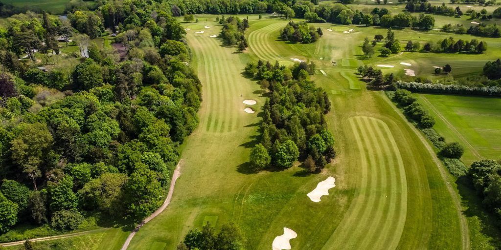 Aerial view of a completed golf course highlighting hole layout, fairways, and hazards.