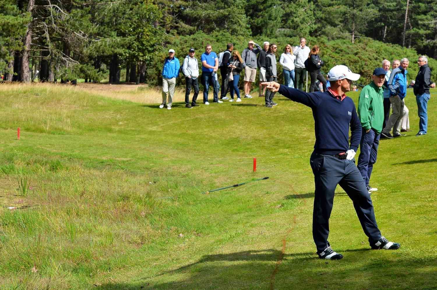 Golfer identifying out-of-bounds area for relief drop under complex golf rules