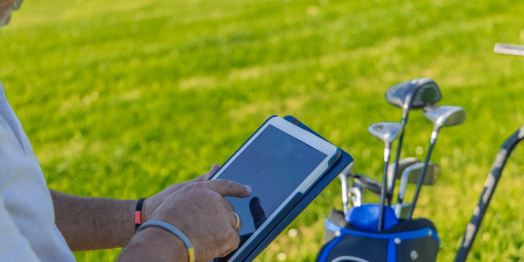 Course manager reviewing golf operations on iPad with management app.
