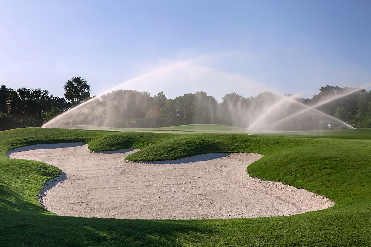 Scenic golf hole managed by powerful golf management system with online tee time reservation and course scheduling tools.