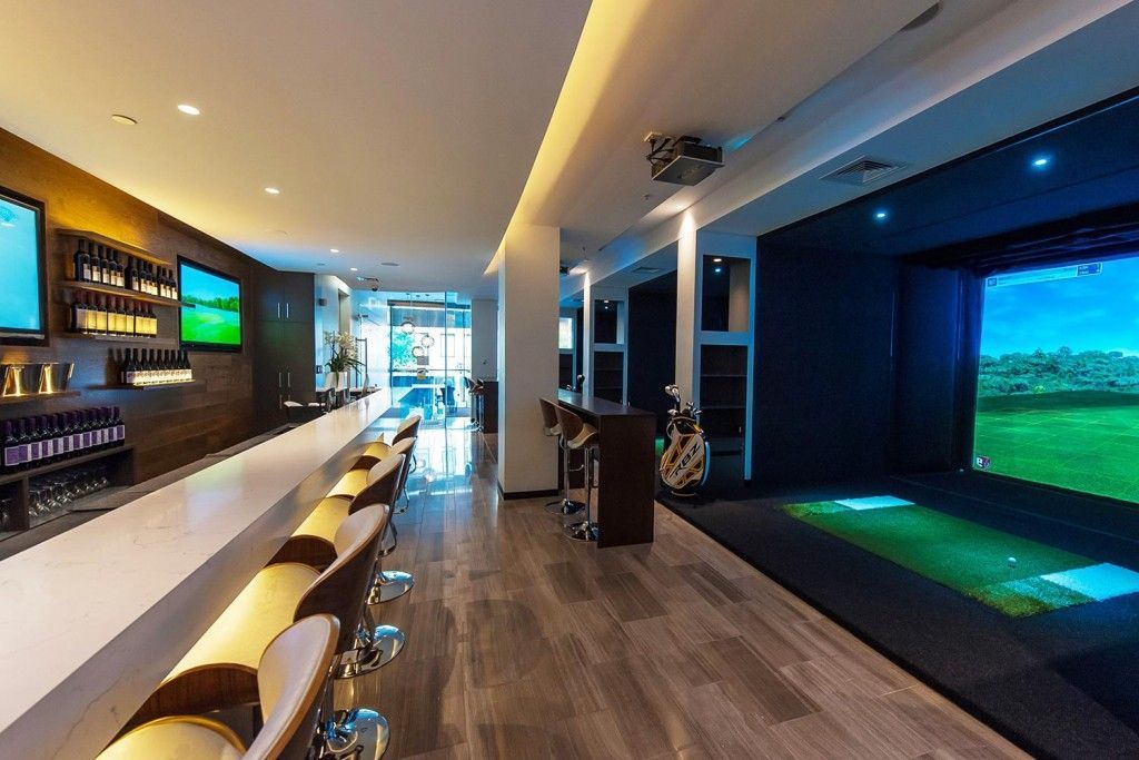 Indoor golf club bar and lounge blending social space with golf amenities – reimagining clubhouse environments for modern members.