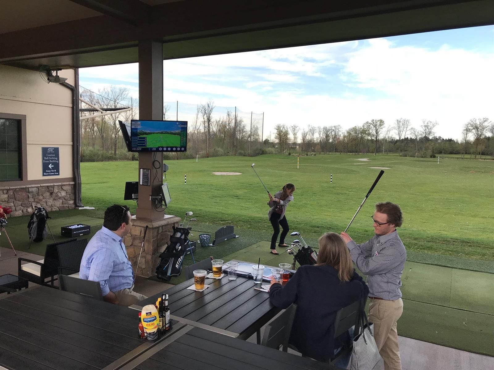 Guests enjoying a lively driving range party at 1757 Golf Club.