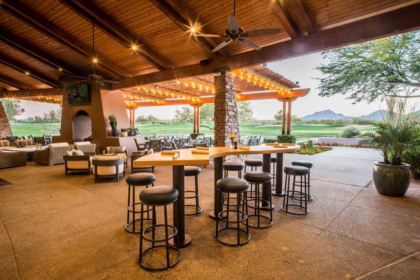 Outdoor dining area at a modern golf clubhouse showcasing social-focused design and elevated member experiences.