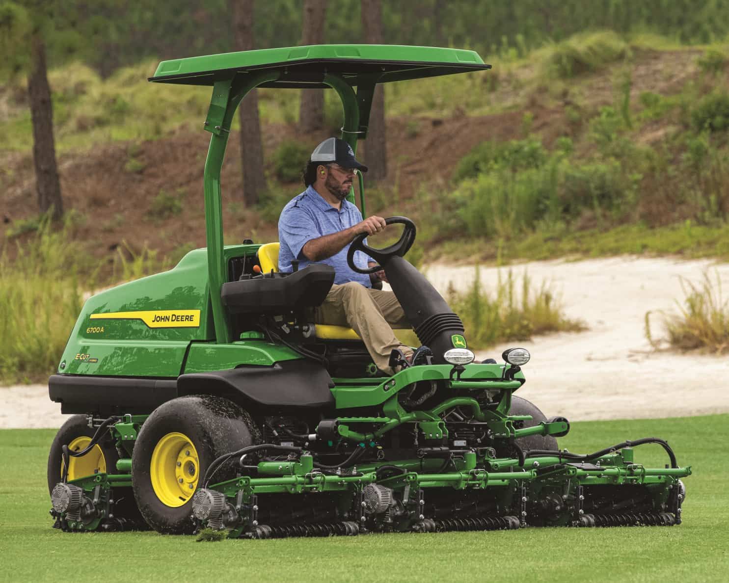 Grounds crew member operating a mower, showcasing connected greenskeeping in action with real-time course management.
