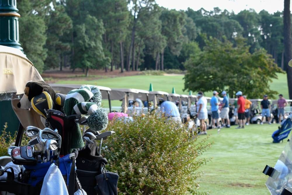 Club tournament day with players in golf carts ready to start.