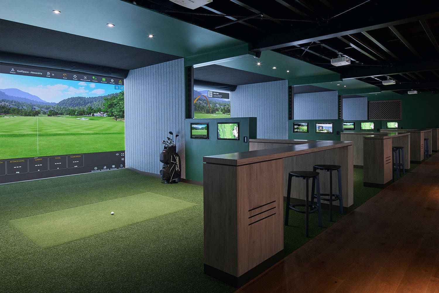 High-tech indoor golf facility with virtual simulators and hitting bays – modern golf experience with immersive technology.