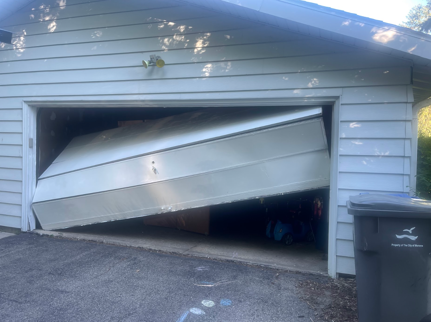 A boat is stuck in a garage door.