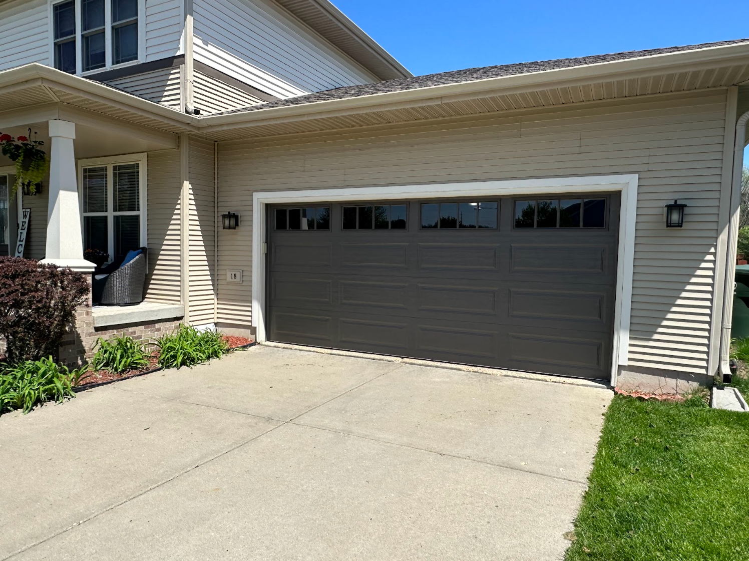 A large garage door is sitting in front of a house.