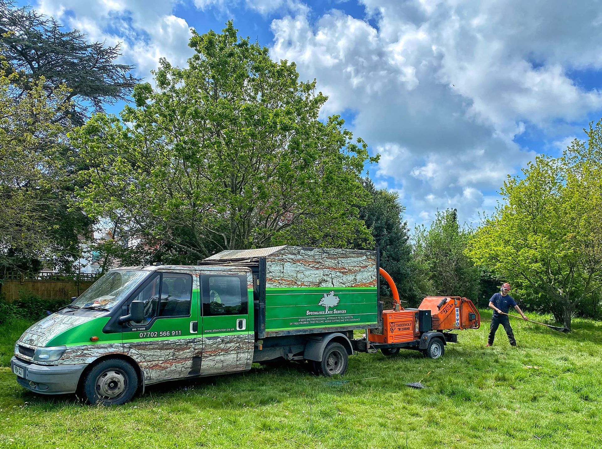 A tree surgeon's van for a tree pruning and stump grinding job.