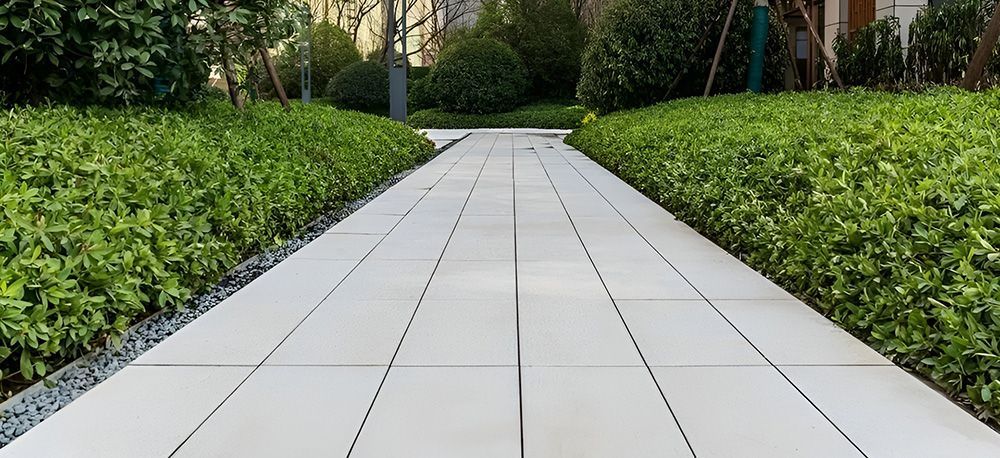 A Stone Path Flanked by Green Hedges