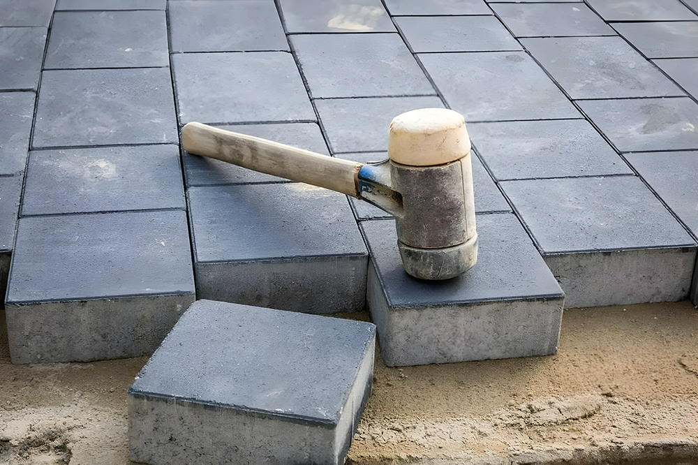 Hammer on Paving Blocks Sand