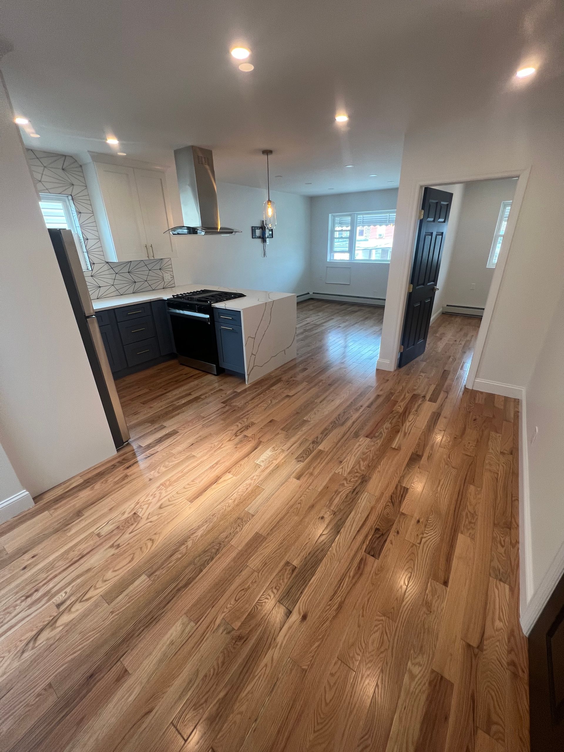 A person is kneeling on the floor holding a hammer. — New Windsor, NY — JJ Interior Restorations Corp.