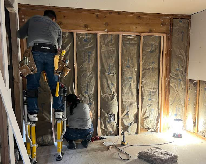 A man and a woman are looking at a clipboard in a room. — New Windsor, NY — JJ Interior Restorations Corp. A man and a woman are looking at a clipboard in a room. — New Windsor, NY — JJ Interior Restorations Corp.