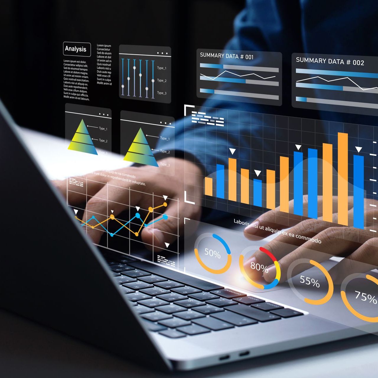 A person is typing on a laptop computer with a graph on the screen.