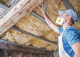 A man in protective gear performing Asbestos Removal