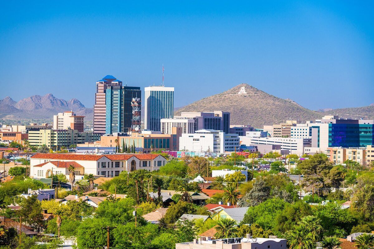 An aerial view of the Tucson skyline with mountains in the background.