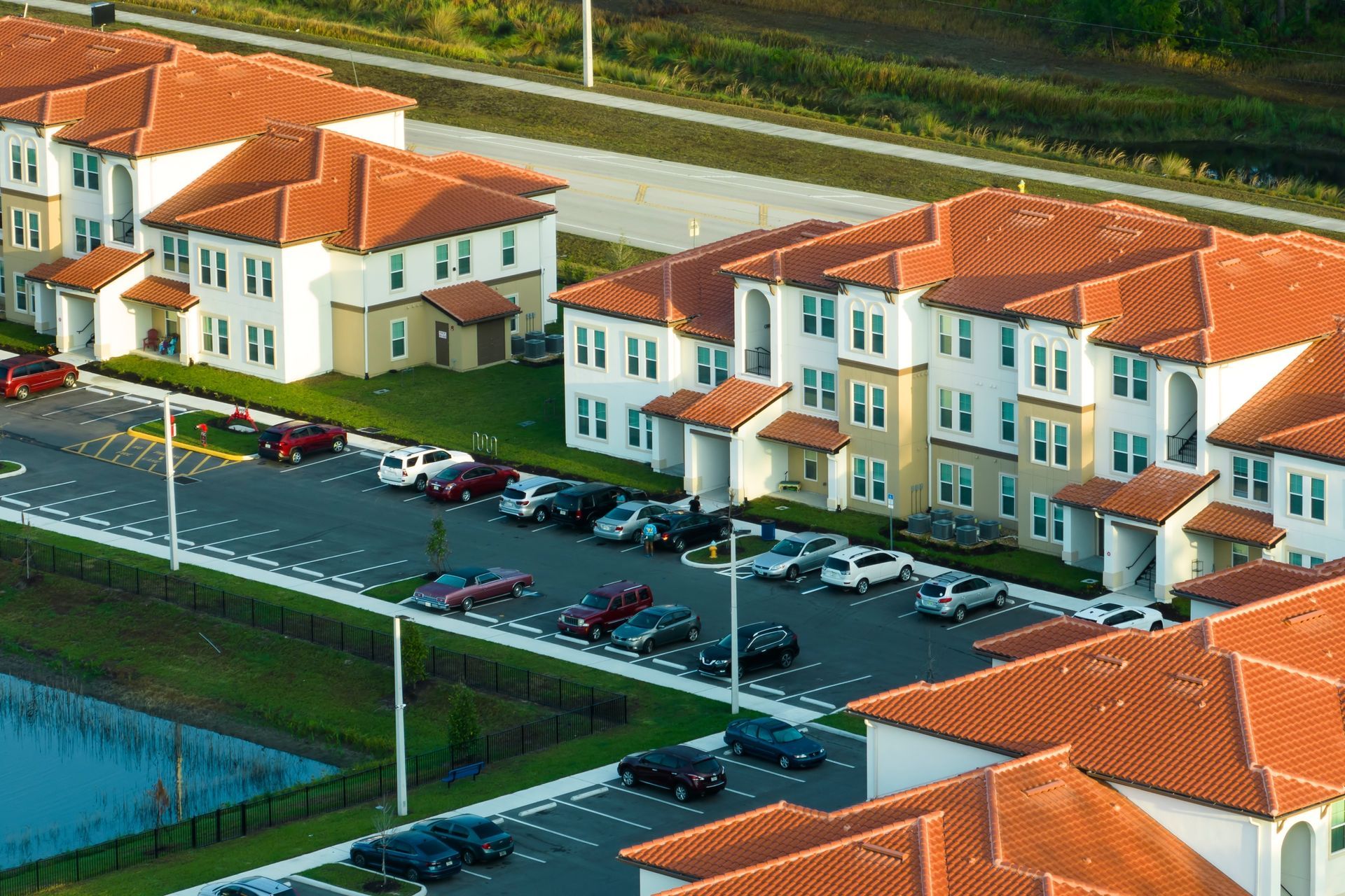 An aerial view of a row of apartment buildings with red tile roofs