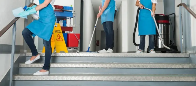 A group of cleaners are cleaning the stairs of a building.