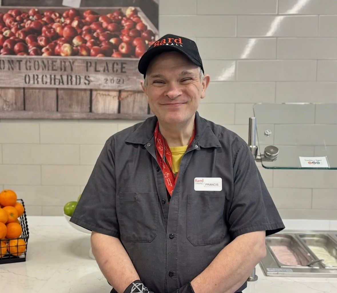 A group of chefs are posing for a picture in a kitchen.