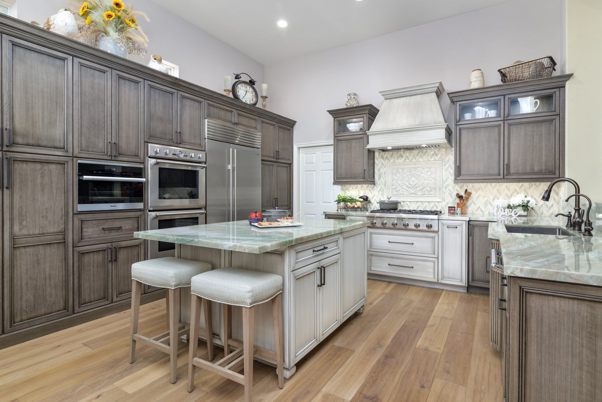 A kitchen with stainless steel appliances , wooden cabinets , and a large island.