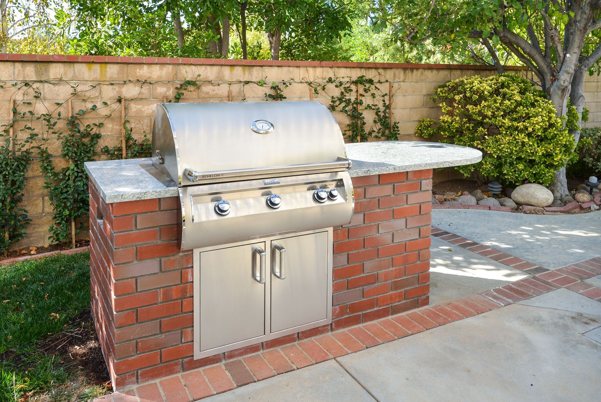 image shows a stainless steel  Barbeque encased in red brick,  Backyard bbq addition, Oak Park, CA 