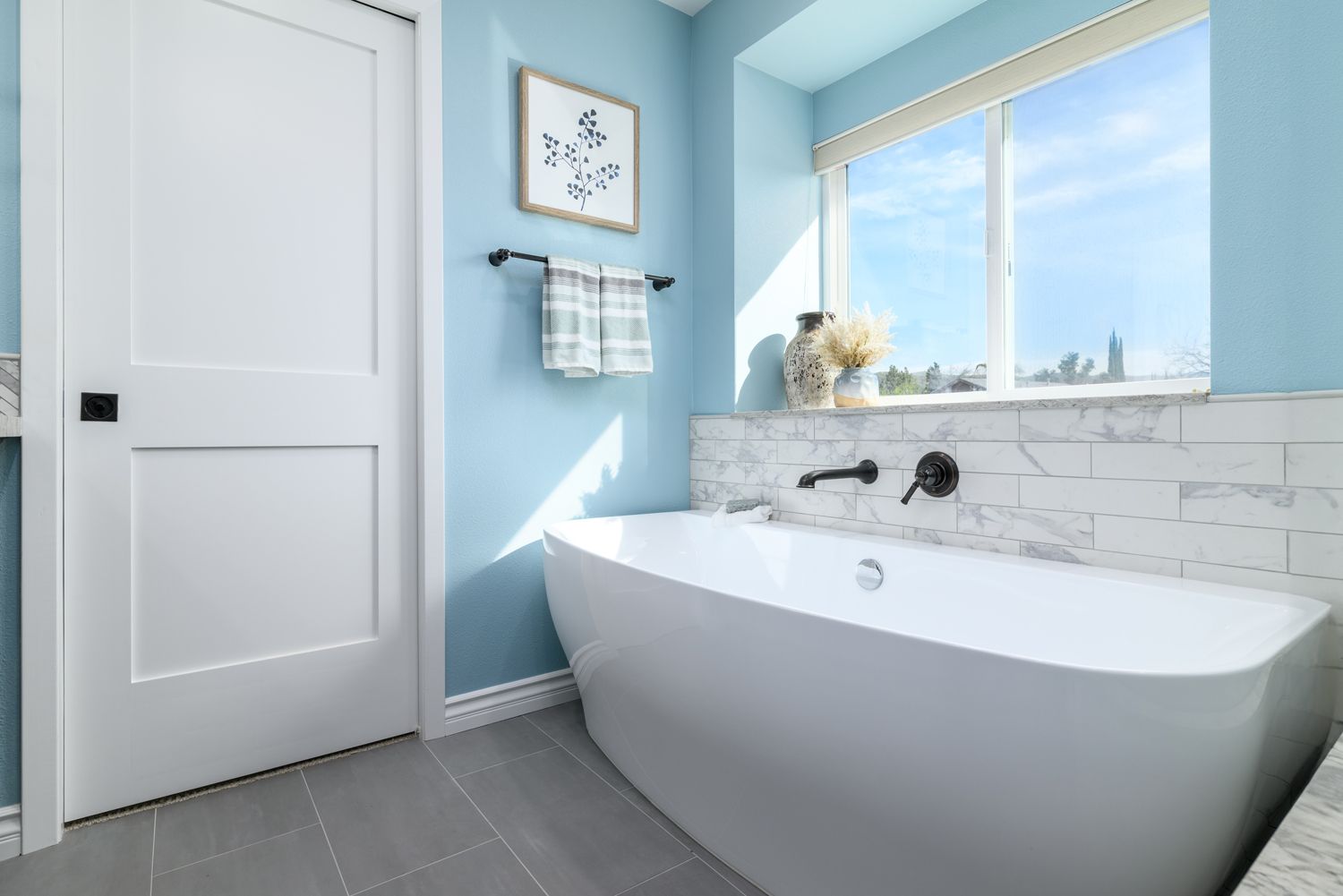 a modern style bathtub with a white and gray subway tile backsplash under new Milgard windows, primary, master bathroom remodel and addition, Oak Park , CA 