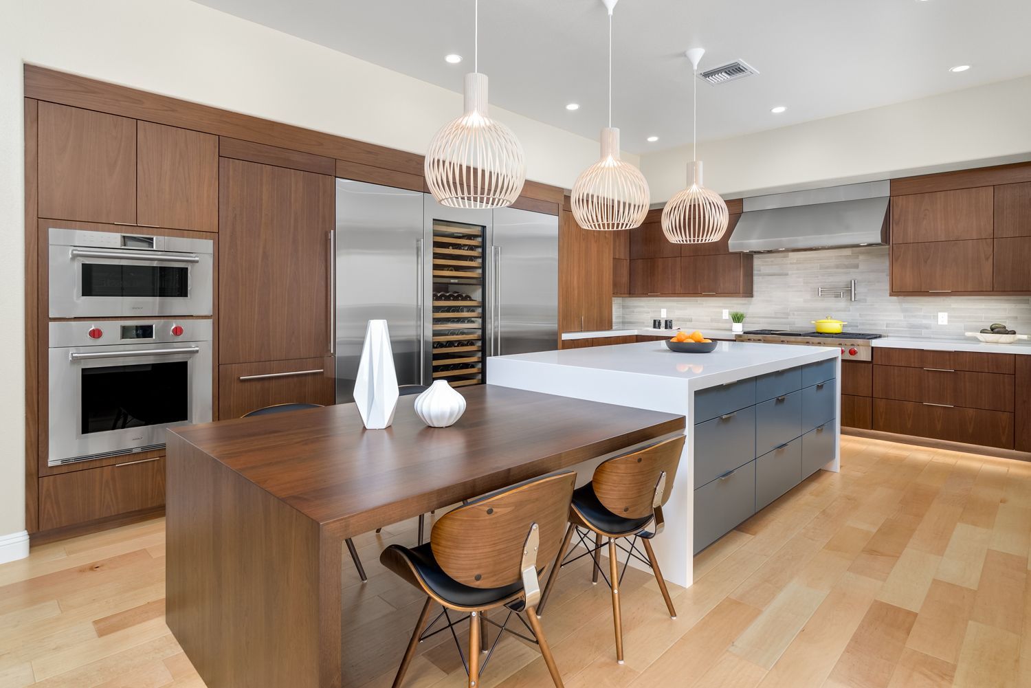 image of modern style kitchen, large center island with wood table, wood & painted cabinets, quartz countertops, wine cooler, stainless steel appliances, kitchen addition, kitchen remodel, kitchen expansion, Thousand Oaks, CA 