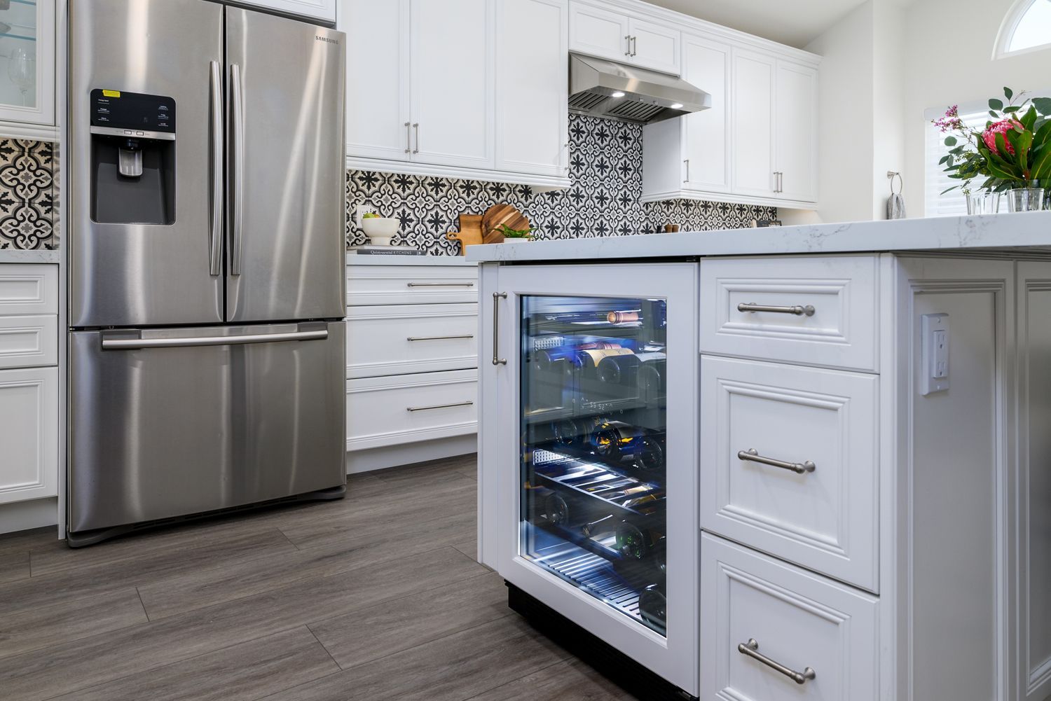 image of the wine fridge in a kitchen with a stainless-steel refrigerator, white cabinets, white quartz countertops, blue and red and white floral backsplash, Thousand Oaks, CA, kitchen remodel, 