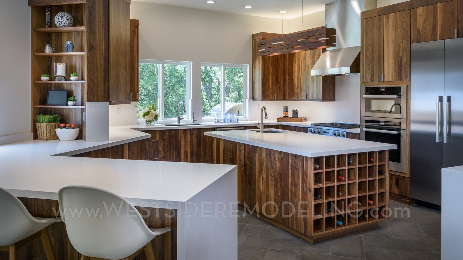 image of a kitchen with walnut cabinetry, bright White Quartz Countertops & Backsplash, island with wine cubbies, kitchen remodel, Westlake Village, CA 