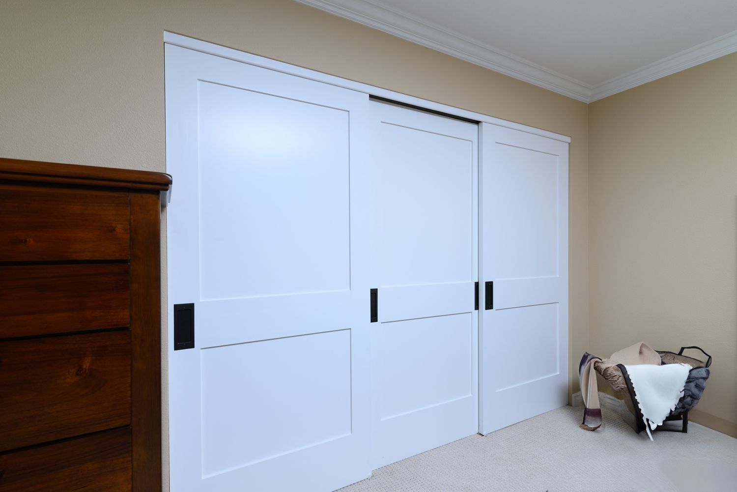 Image of a large white closet with 3 doors in a home's primary bedroom- Oak Park, CA primary bathroom and bedroom addition and remodel  