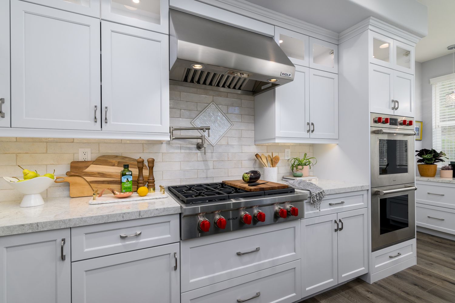 White glossy ceramic backsplash tile and cooktop with red control knobs in Thousand Oaks Transitional Kitchen Remodel 